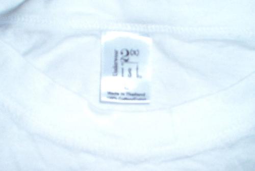 White T - Detail of T-shirt neck opening with tag. White T - Detail of T-shirt neck opening with tag.