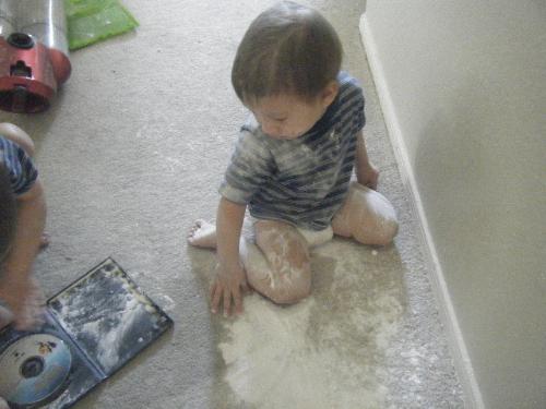 My two babies with baking soda - It only took a moment...but the three year old went downstairs and found a box of baking soda. I guess he felt the baby smelled or something because he then dumped the WHOLE box over the baby's head. Joys...
