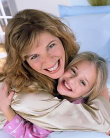 A good mother - a mother snuggles her little daughter.