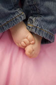 Footprints - Baby with a pair of jeans on with feet out