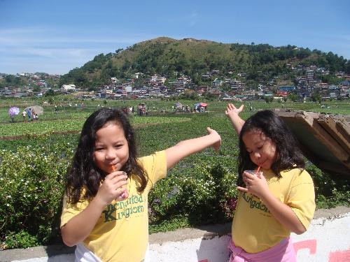 Baguio City, Philippines - Twins at Strawberry Farm, enjoying their Strawberry flavoured Taho