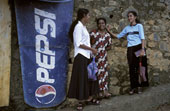 Pepsi - Two people standing beside a Pepsi Cola sign
