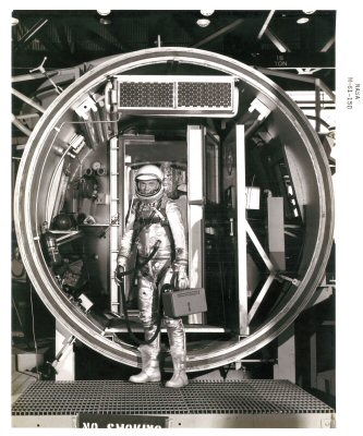 Astronauts with hand held atmospheric control. - Here you see a picture of astronauts with portable air conditioners.