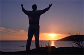 Worship - Man on beach raising his hands in worship
