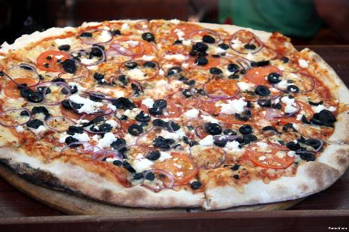 Fresh Hot Pizza - Fresh Hot Pizza with lot's of delicious toppings that includes; black olives and tomatoes.