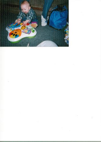 The Grand baby - this is a picture of the Grand baby playing.It was taken at Grandpa House. the photo was taken right before Thanksgiving dinner.