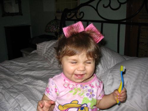Izzy getting her hair done - This is a picture of my youngest girl. Of course, she is interested in putting the curlers in her mouth rather than her hair but I managed to get a couple in there. She keeps them in just long enough for me to snap this picture and then a yank and a tug and its out of her hair into her mouth.