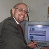 Gilberto Cintron - This is a picture of Gilberto Cintron at his home based business, he works from his PC.