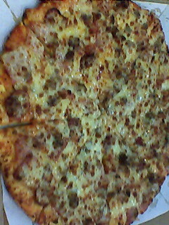 manhattan pizza - this is a yellow can Manhattan pizza.. we love it because it has a lot of meat toppings on it. we made it extra special by adding more cheese on it. yum yum yum!!