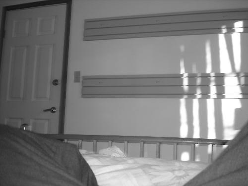 Sunlight through Blinds - I like how bright the sunlight is compared to the darkness of this room It's in black and white too which made the picture brighter and better for this site I think