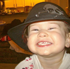 My silly Bug - She loves hats, and Bubby has lots of them. She likes the fedora best.