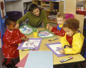 Craft - Preschool Teacher Showing Children How To Paint