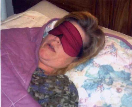 sleep mask - a woman sleeping with her sleep mask on.