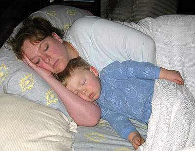 mother and kid sleeping - mother and her kid sleeping in their bed.
