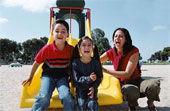 playing - Children playing outdoors on a playground slide.