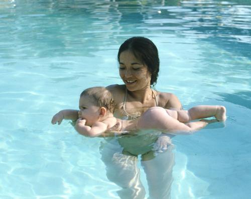 mother and baby - a mom teaching his baby to swim