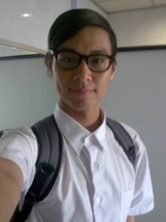 student - a nerdy-looking student smiles for a shot.