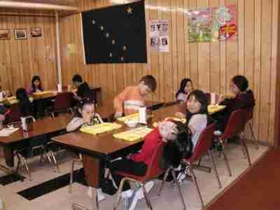 school cafeteria - students eating their meal at a school cafeteria