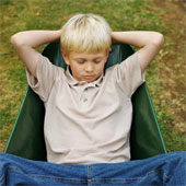 sleeping - Front view of boy sleeping in wheelbarrow