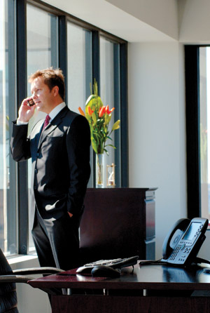office - a man calling on his cellphone at his office.
