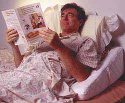 reading in bed - a man reading in bed, about to get some sleep.
