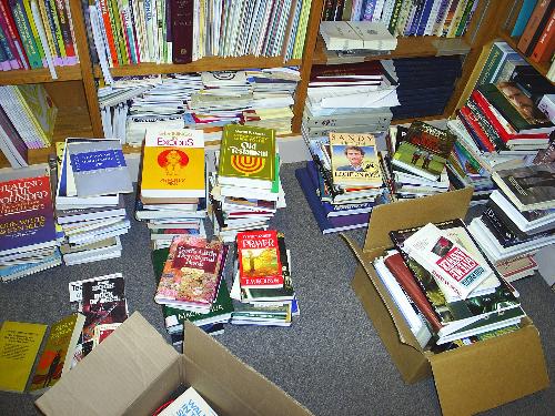 pile of books - piles and piles of books in a library