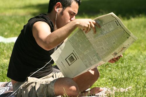 reading newspaper - a guy reading the newspaper, catching up with the news.