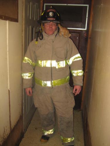 My boyfriend in his fireman gear - This is my boyfriend in his fireman gear. And no, he did not save that cat from a tree. LOL
