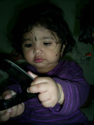 My daughter - My daughter playing with a mobile phone.