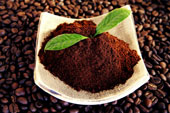 coffee - A small plate of coffee ground put on top of the coffee beans