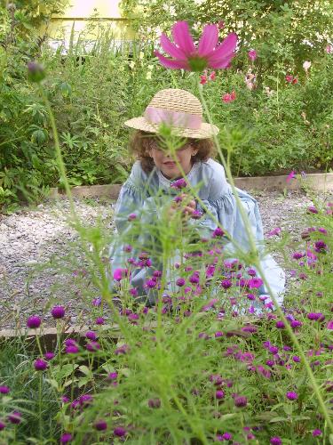 smelling flowers - my daughter smelling flowers at the museum's garden