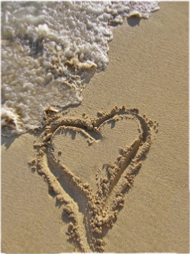 love symbol in sand - love symbol in sand near a sea in india.