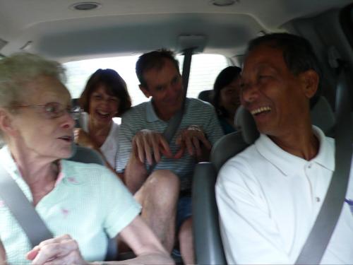laughing - a group of friends laughing inside the car.