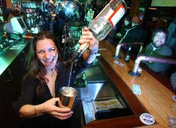 Bartender in action - A bartender doing what she does best.  