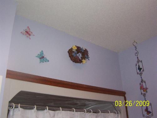 Just above the shower curtain - Here's the butterflies that I cut off a stick that was to be put outside as a decoration but I used wire cutters to cut them off and hung them on the wall! And the butterfly wind chime that I bought too.