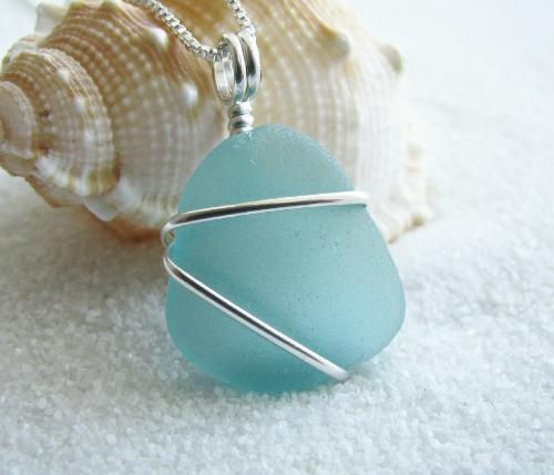 Soft Aqua Sea Glass Necklace - This piece of soft aqua blue sea glass is practically flawless. Beautifully frosted and smooth from it's time spent tumbling around in the ocean, this piece of sea glass is approx 3/4'L and wrapped with sterling silver wire. The sea glass pendant hangs on an 18' sterling silver Venetian box-style chain. A great Mother's Day gift and perfect for the spring & summer!