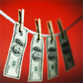 laundering - Close-up of one hundred dollar bills hanging on clothesline