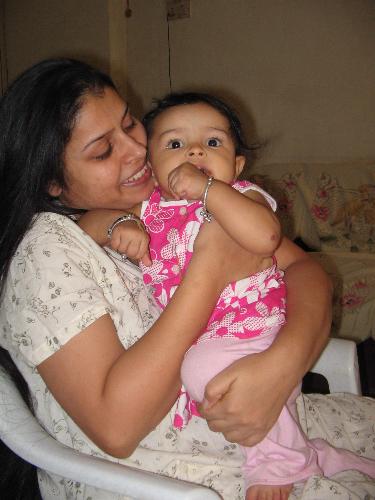 me and my baby - this is me and thats my naughty naughty baby. tis is her old picture. now she has turned one and i have gone a little bit slim as compared to this picture. this is her room and there are toys all over. i am sitting on a chair and she wants to make me fall from that. she is pushing me down on the floor. she is very naughty and she hardly sleeps in night so i have to baby sit the whole night. the best part is that she is not a cry baby. otherwise it would have been very difficult for me to handle her alone because my hbby has to dop other works as well as look after his businesss too.