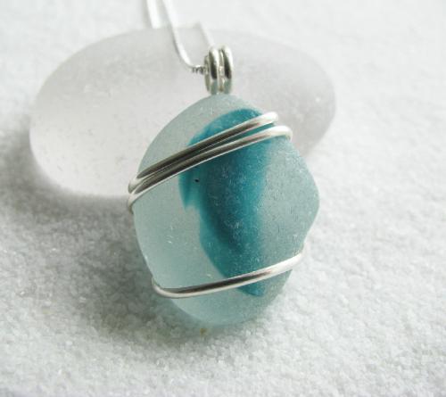 Blue Splash Multi Color Sea Glass Necklace - A beautiful piece of authentic English sea glass, measuring approx 7/8'L is wrapped in sterling silver wire and hangs on a 18' sterling silver Venetian box-style chain. The piece of sea glass, is a frosty clear with a wonderful splash of aqua blue color. Absolutely gorgeous, especially when it's in the sunlight!