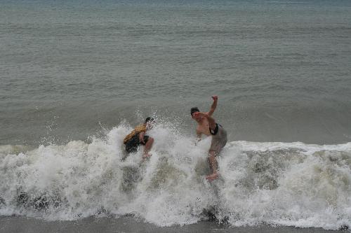 Surfing without the board..hahahahaha... - We went to a beach in Zambales without knowing that it is one of the best surfing sites during the December Season..We were surprised to see lots and lots of surf-able WAVES coming and thundering the shores..WOOOOWWWW..awesome..So my German friend, Janis and I went to 'ride' on the waves..hahahaha..but we don't have the boards... stil we have lots and lots of fun doing it..and because of what we did people and children (without boards too!) came and join us..Jumping! Screaming! when the waves pushed them..pulled them! took them over! rolled them! wow..wow..we don't know the exact name of the game but we enjoyed it so much..think we lost pounds of fats during that day and gained lots of friends,,,\\\\never never see any deficiency as stumbling blocks to your happiness..opportunities to enjoy life is in every thing we do even if we feel we lack the faculties or facilities..hahahahaha...enjoy life