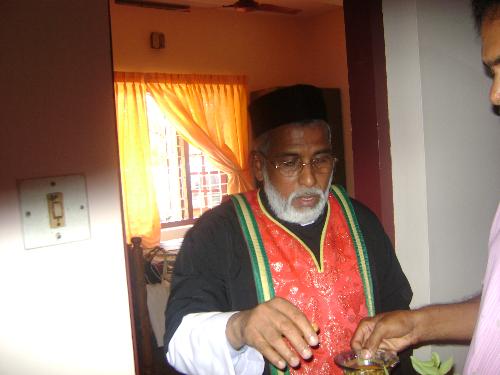 A priest inded. - A priest doing his job in house.