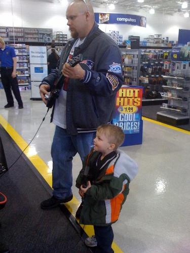 My husband and son rocking to Guitar Hero at Best  - My husband and son rocking to Guitar Hero at Best Buy