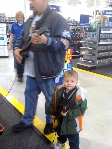 My husband and son rocking to Guitar Hero at Best  - My husband and son rocking to Guitar Hero at Best Buy