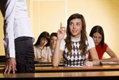 question - emale student raising finger to answer question during school seminar