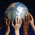 Earth Day - A bunch of hands holding up the earth.