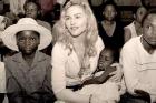 madonna and an orphan - shows pop star madonna cradling an orphan.