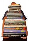 Books - A picture of someone holding a pile of books.