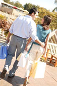 shopping - Affectionate couple carrying shopping bags.