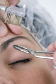 Eyebrows - Woman in a beauty shop getting eyebrows plucked