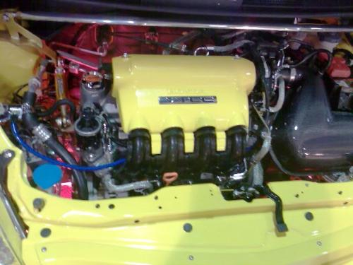 Cars - An engine with parts painted yellow and polished for glam look.